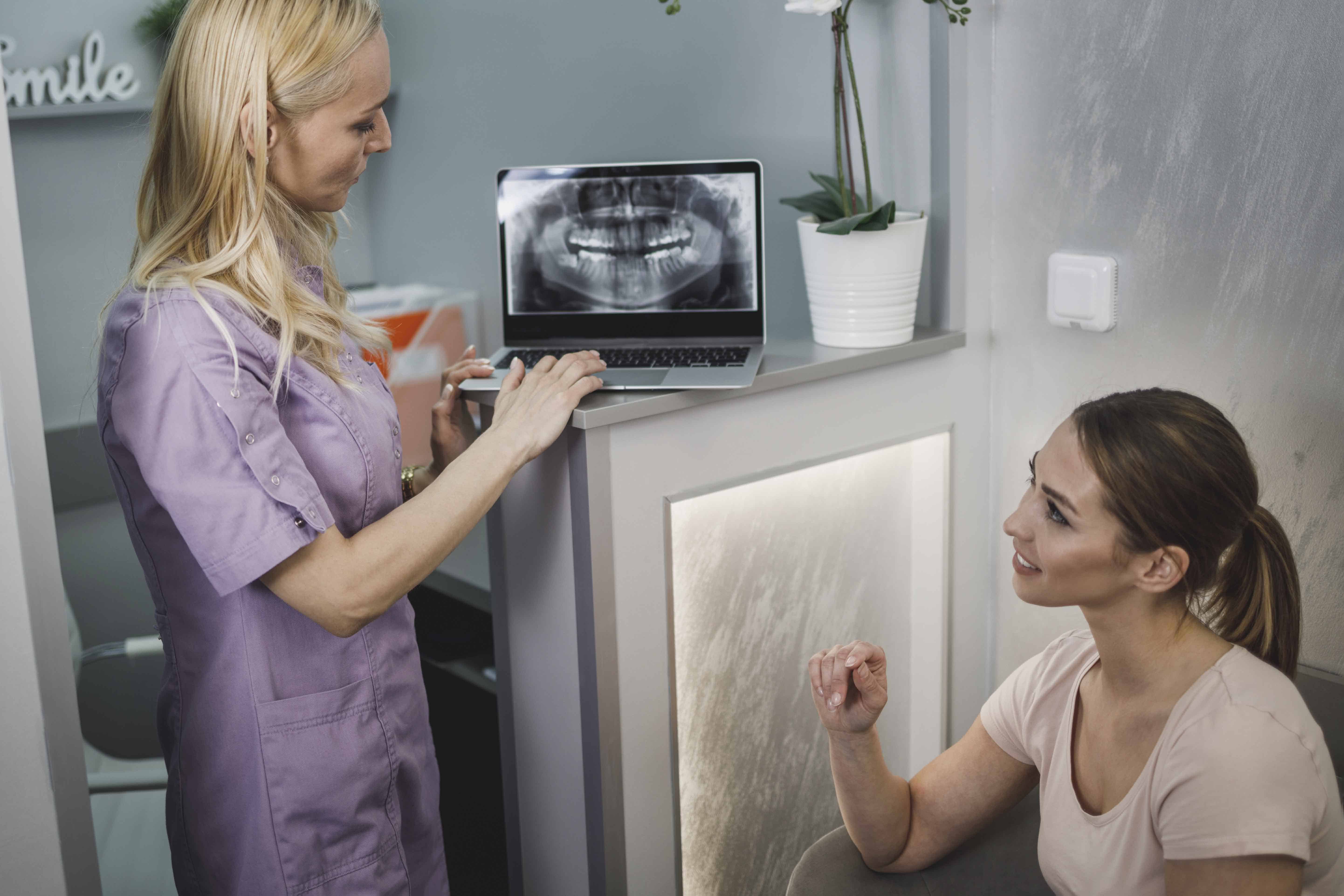 Doctor Explaining Tooth X-Rays To A Patient
